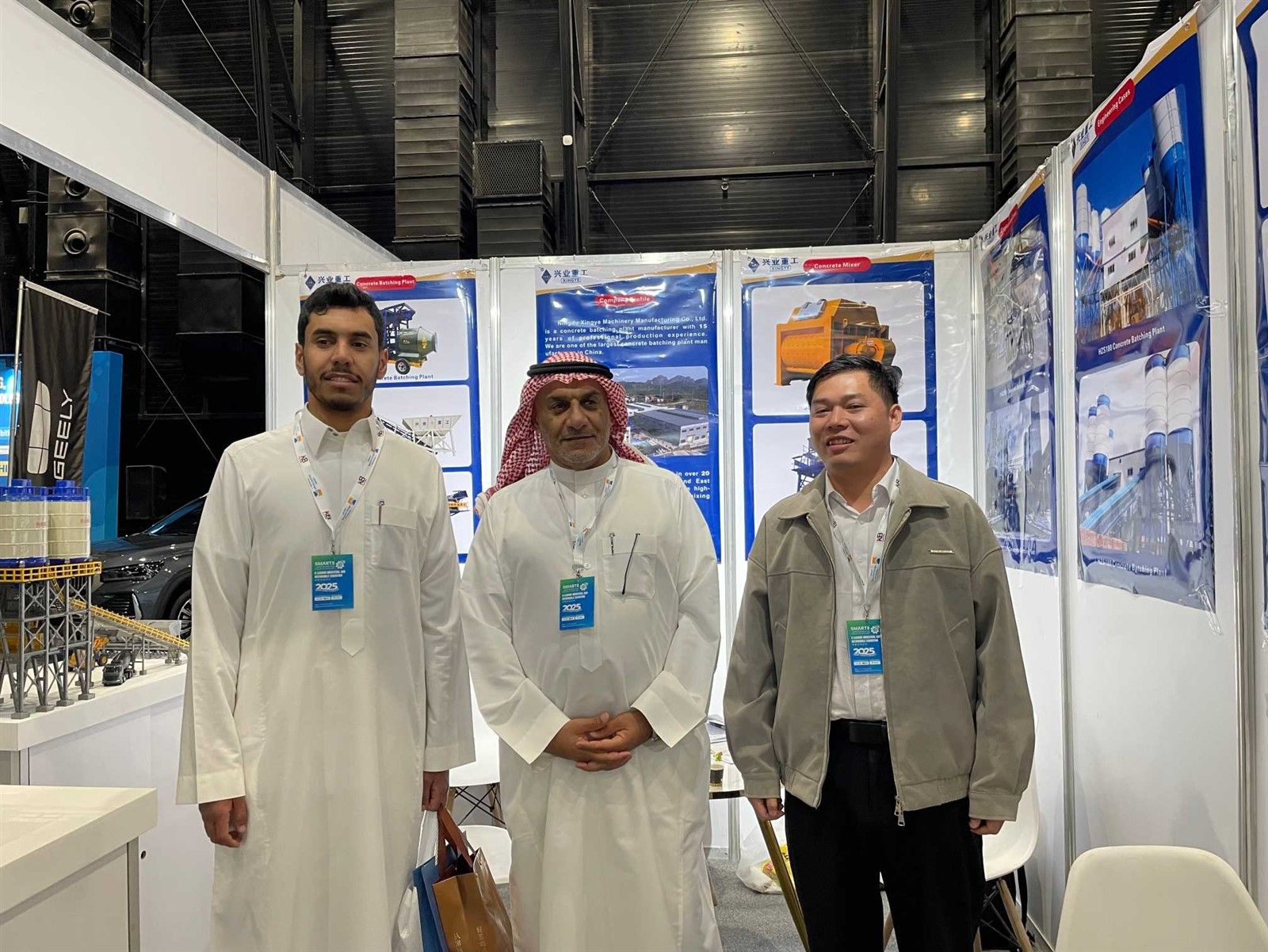 Contractors reviewing modular concrete batching plant blueprints at the Saudi Riyadh International Industry Expo